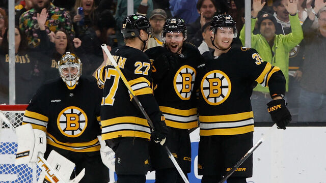 BOSTON, MASSACHUSETTS - DECEMBER 06: Andrew Peeke #26 of the Boston Bruins celebrates his goal against the New Jersey Devils with teammates Hampus Lindholm #27, Morgan Geekie #39 and Jeremy Swayman #1 during the third period at the TD Garden on December 6, 2025 in Boston, Massachusetts. The Bruins won 4-1.