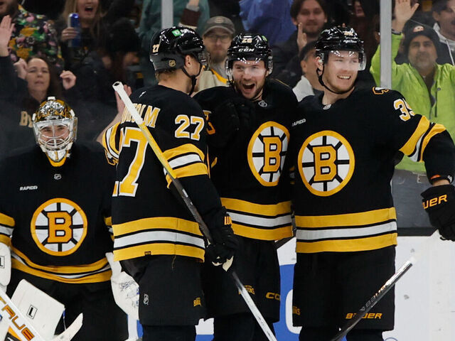 BOSTON, MASSACHUSETTS - DECEMBER 06: Andrew Peeke #26 of the Boston Bruins celebrates his goal against the New Jersey Devils with teammates Hampus Lindholm #27, Morgan Geekie #39 and Jeremy Swayman #1 during the third period at the TD Garden on December 6, 2025 in Boston, Massachusetts. The Bruins won 4-1.