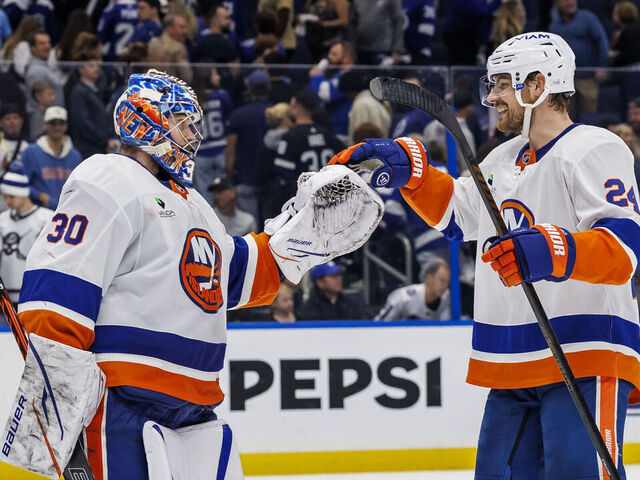 TAMPA, FL - DECEMBER 6: Goalie Ilya Sorokin #30 and Scott Mayfield #24 of the New York Islanders celebrate the win against the Tampa Bay Lightning at Benchmark International Arena on December 6, 2025 in Tampa, Florida.