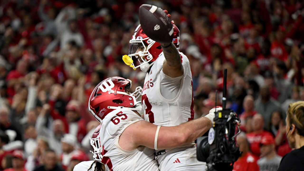 INDIANAPOLIS, INDIANA - DECEMBER 06: Elijah Sarratt #13 of the Indiana Hoosiers celebrates with Carter Smith #65 after catching a touchdown in the third quarter against Jermaine Mathews Jr. #7 of the Ohio State Buckeyes during the 2025 Big Ten Football Championship at Lucas Oil Stadium on December 06, 2025 in Indianapolis, Indiana.