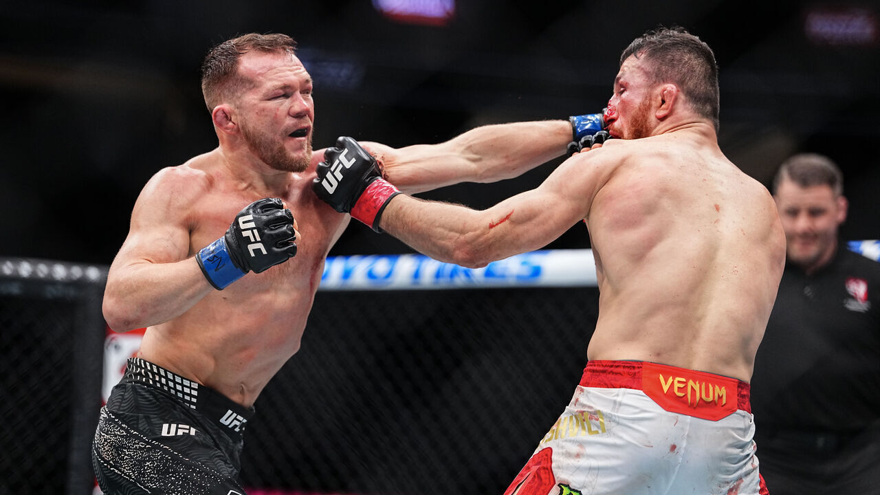LAS VEGAS, NEVADA - DECEMBER 06: (L-R) Petr Yan of Russia punches Merab Dvalishvili of Georgia in the UFC bantamweight championship fight during the UFC 323 event at T-Mobile Arena on December 06, 2025 in Las Vegas, Nevada.
