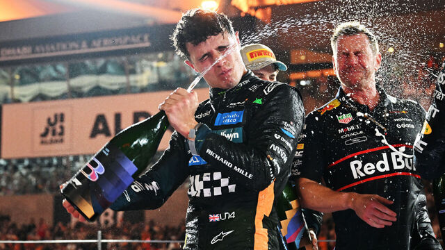 ABU DHABI, UNITED ARAB EMIRATES - DECEMBER 07: 2025 F1 World Drivers Champion and Third placed Lando Norris of Great Britain and McLaren celebrates with Champagne on the podium during the F1 Grand Prix of Abu Dhabi at Yas Marina Circuit on December 07, 2025 in Abu Dhabi, United Arab Emirates.