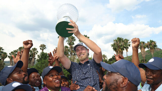 SUN CITY, SOUTH AFRICA - DECEMBER 07: Kristoffer Reitan of Norway holds the trophy as he celebrates victory on the 18th green on day four of the Nedbank Golf Challenge in honour of Gary Player 2026 at Gary Player CC on December 07, 2025 in Sun City, South Africa.