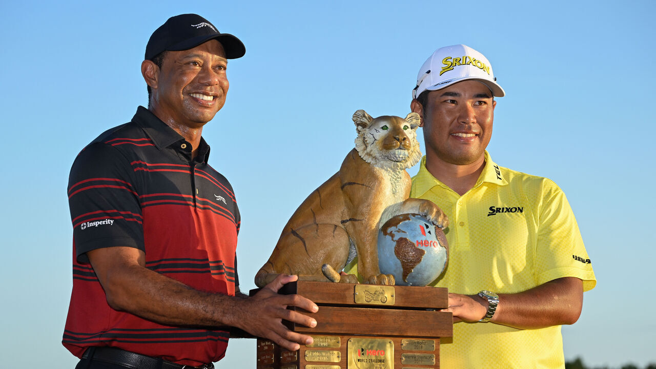 NASSAU, BAHAMAS - DECEMBER 07: Tiger Woods and Hideki Matsuyama of Japan stand with the trophy on the 18th green after the final round of the Hero World Challenge at Albany Golf Course on December 7, 2025 in Naussau, New Providence.