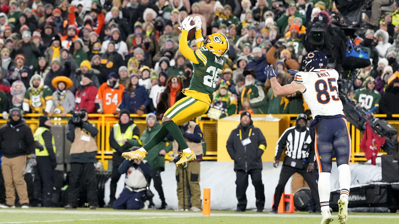 GREEN BAY, WISCONSIN - DECEMBER 07: Keisean Nixon #25 of the Green Bay Packers catches an interception during the fourth quarter against the Chicago Bears at Lambeau Field on December 07, 2025 in Green Bay, Wisconsin.
