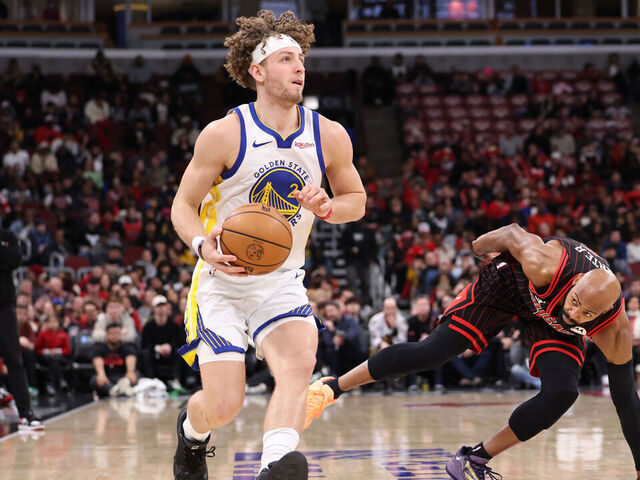 CHICAGO, ILLINOIS - DECEMBER 7: Brandin Podziemski #2 of the Golden State Warriors dribbles past Jevon Carter #5 of the Chicago Bulls during the second half at the United Center on December 7, 2025 in Chicago, Illinois.