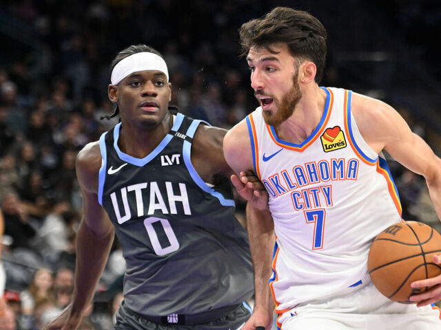 SALT LAKE CITY, UTAH - DECEMBER 07: Chet Holmgren #7 of the Oklahoma City Thunder drives into Taylor Hendricks #0 of the Utah Jazz during the second half of a game at Delta Center on December 07, 2025 in Salt Lake City, Utah.