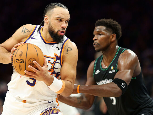 MINNEAPOLIS, MINNESOTA - DECEMBER 08: Dillon Brooks #3 of the Phoenix Suns goes to the basket against Anthony Edwards #5 of the Minnesota Timberwolves in the third quarter at Target Center on December 08, 2025 in Minneapolis, Minnesota. The Suns defeated the Timberwolves 108-105.