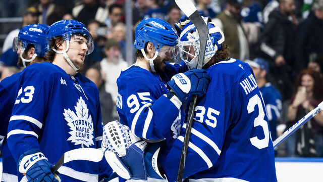 TORONTO, CANADA - DECEMBER 8: Oliver Ekman-Larsson #95 congratulates Dennis Hildeby #35 of the Toronto Maple Leafs on a shutout following a win over the Tampa Bay Lightning at the Scotiabank Arena on December 8, 2025 in Toronto, Ontario, Canada.