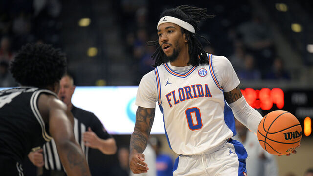 SAN DIEGO, CALIFORNIA - NOVEMBER 28: Boogie Fland #0 of the Florida Gators dribbles the ball during the first half against the Providence Friars in the Rady Children's Invitational at Jenny Craig Pavilion on November 28, 2025 in San Diego, California.