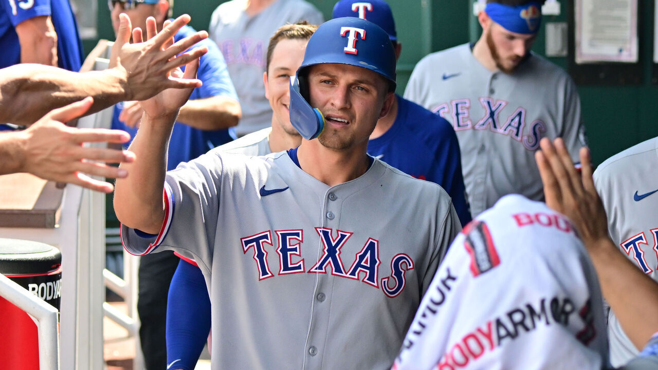 KANSAS CITY, MO - AUG 21: Texas Rangers shortstop Corey Seager (5) is congratulated by teammates after scoring during a MLB game between the Texas Rangers and the Kansas City Royals on August 21, 2025, at Kauffman Stadium in Kansas City, MO.