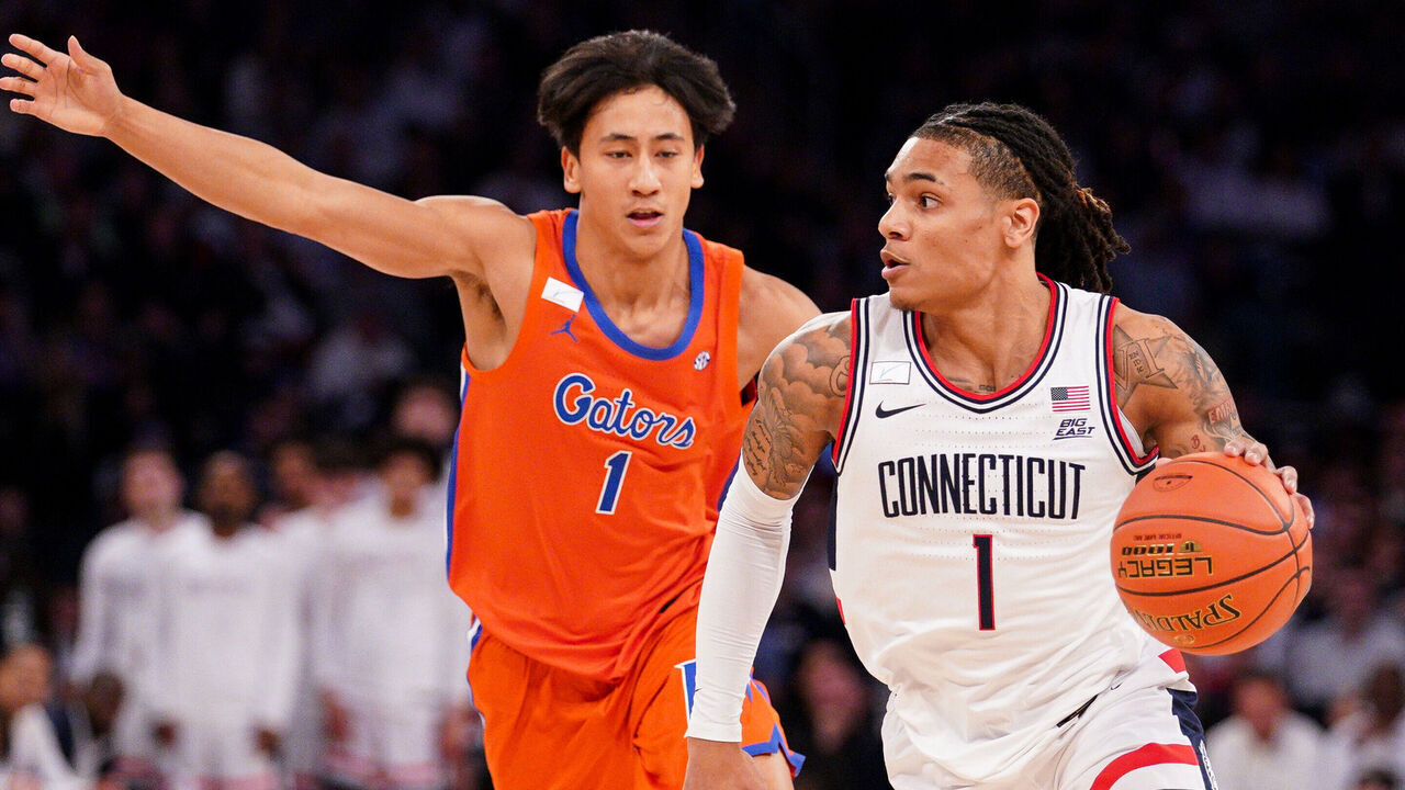 NEW YORK, NEW YORK - DECEMBER 09: Solo Ball #1 of the UConn Huskies crives ahead of Xaivian Lee #1 of the Florida Gators in the first half at Madison Square Garden on December 09, 2025 in New York City.