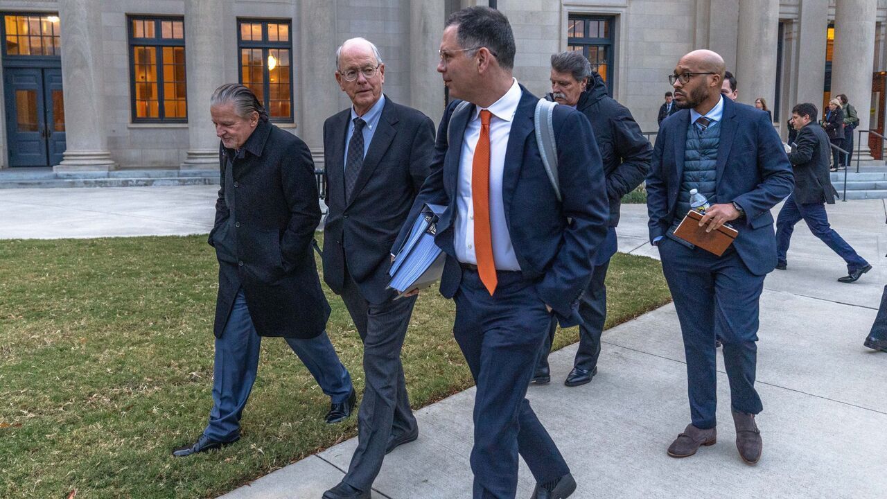 CHARLOTTE, NORTH CAROLINA - DECEMBER 1: Jim France (C), NASCAR chairman and CEO, departs the Charles R Jonas Federal Building on December 1, 2025 in Charlotte, North Carolina. Jury selection and an opening statement began an antitrust lawsuit filed by Michael Jordan's 23XI Racing team against NASCAR.
