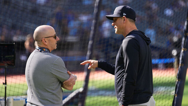 TORONTO, ONTARIO - OCTOBER 05: (L-R) Brian Cashman, Senior Vice President and General Manager of the New York Yankees, and Aaron Boone #17 of the New York Yankees speak before game two of the American League Division Series against the Toronto Blue Jays at Rogers Centre on October 05, 2025 in Toronto, Ontario.