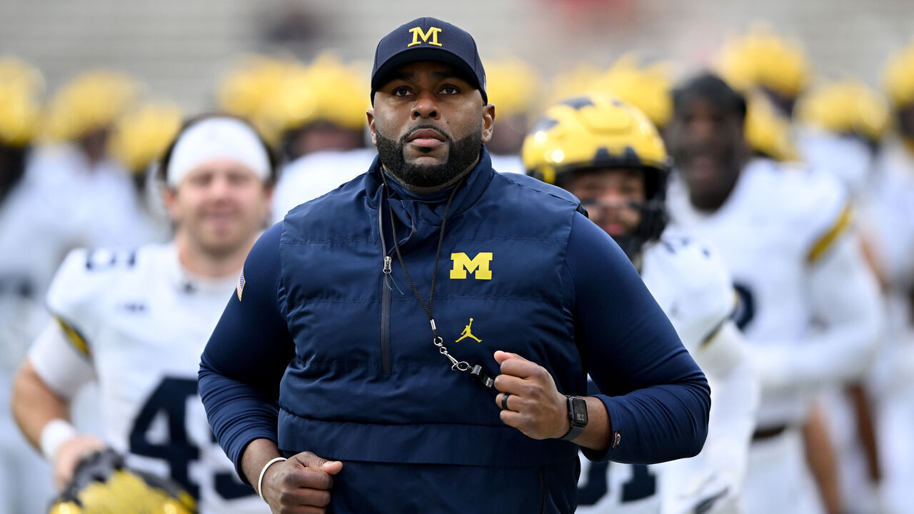 COLLEGE PARK, MARYLAND - NOVEMBER 22: Head coach Sherrone Moore of the Michigan Wolverines leads his team off the field after warm-ups before the game against the Maryland Terrapins at SECU Stadium on November 22, 2025 in College Park, Maryland.
