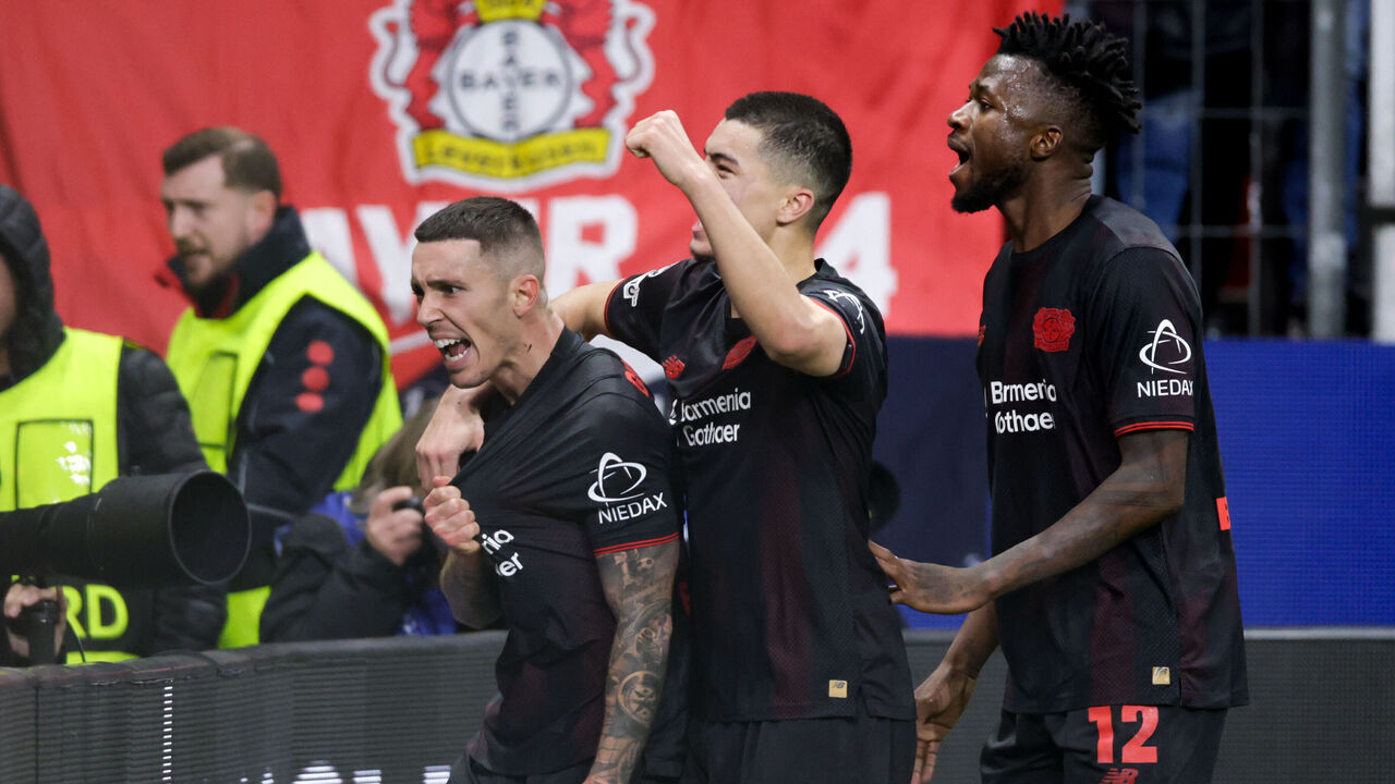 LEVERKUSEN, GERMANY - DECEMBER 10: Alejandro Grimaldo of Bayer 04 Leverkusen celebrates after scoring the team's second goal with Ibrahim Maza of Bayer 04 Leverkusen and Edmond Tapsoba of Bayer 04 Leverkusen during the UEFA Champions League 2025/26 League Phase MD6 match between Bayer 04 Leverkusen and Newcastle United FC at BayArena on December 10, 2025 in Leverkusen, Germany.