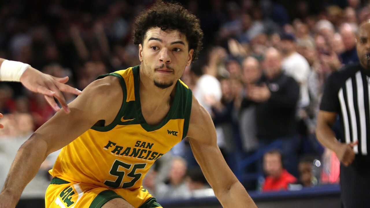 SPOKANE, WASHINGTON - JANUARY 25: Marcus Williams #55 of the San Francisco Dons controls the ball against Ryan Nembhard #0 of the Gonzaga Bulldogs in the second half at McCarthey Athletic Center on January 25, 2024 in Spokane, Washington. Gonzaga defeats San Francisco 77-72.