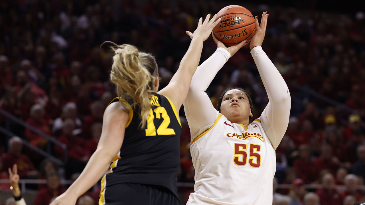 AMES, IOWA - DECEMBER 10: Audi Crooks #55 of the Iowa State Cyclones takes a shot as Layla Hays #12 of the Iowa Hawkeyes blocks in the first half of play at Hilton Coliseum on December 10, 2025, in Ames, Iowa.