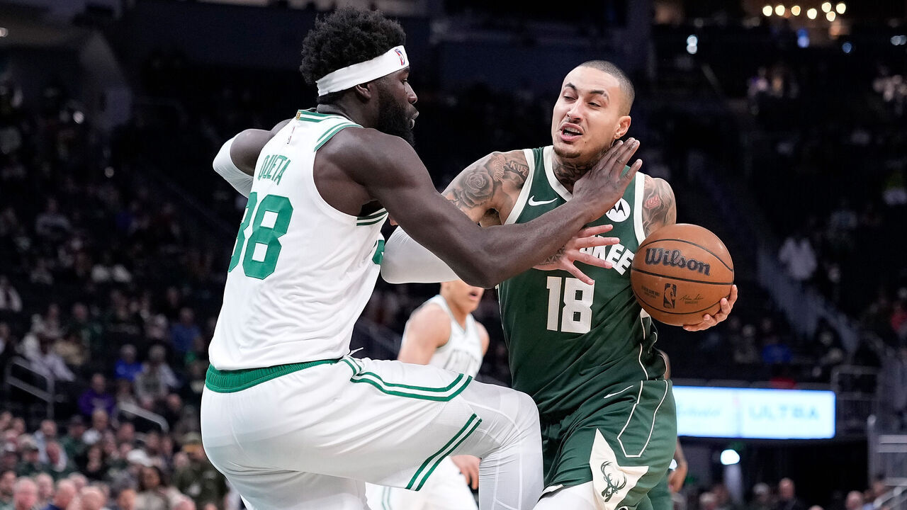 MILWAUKEE, WISCONSIN - DECEMBER 11: Kyle Kuzma #18 of the Milwaukee Bucks is fouled driving to the basket by Neemias Queta #88 of the Boston Celtics during the first half at Fiserv Forum on December 11, 2025 in Milwaukee, Wisconsin.