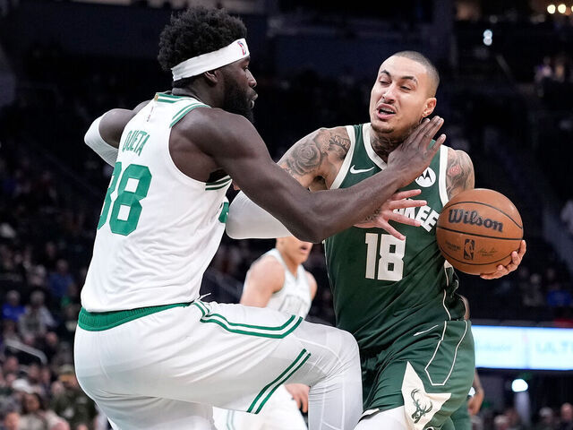 MILWAUKEE, WISCONSIN - DECEMBER 11: Kyle Kuzma #18 of the Milwaukee Bucks is fouled driving to the basket by Neemias Queta #88 of the Boston Celtics during the first half at Fiserv Forum on December 11, 2025 in Milwaukee, Wisconsin.