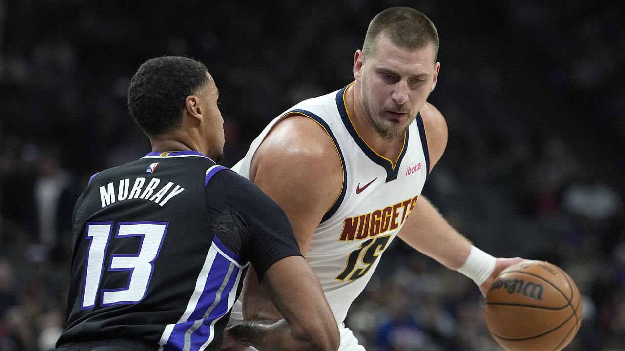 SACRAMENTO, CALIFORNIA - DECEMBER 11: Nikola Jokic #15 of the Denver Nuggets backs in on Keegan Murray #13 of the Sacramento Kings in the first half at Golden 1 Center on December 11, 2025 in Sacramento, California.