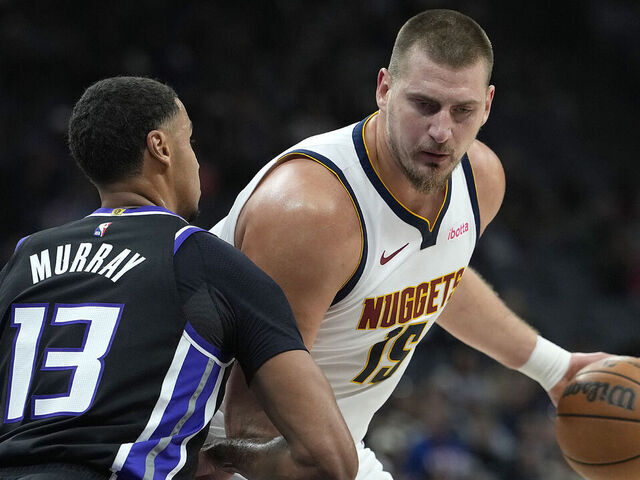 SACRAMENTO, CALIFORNIA - DECEMBER 11: Nikola Jokic #15 of the Denver Nuggets backs in on Keegan Murray #13 of the Sacramento Kings in the first half at Golden 1 Center on December 11, 2025 in Sacramento, California.