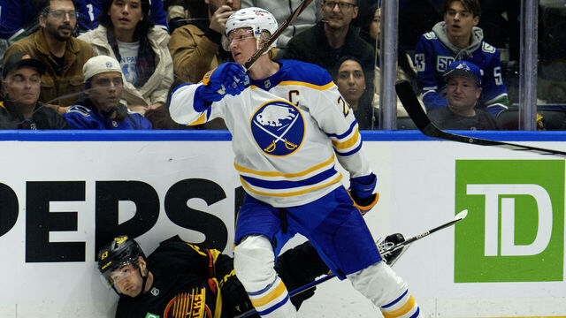 VANCOUVER, CANADA - DECEMBER 11: Rasmus Dahlin #26 of the Buffalo Sabres checks Max Sasson #63 of the Vancouver Canucks during the third period of their NHL game at Rogers Arena on December 11, 2025 in Vancouver, British Columbia, Canada.