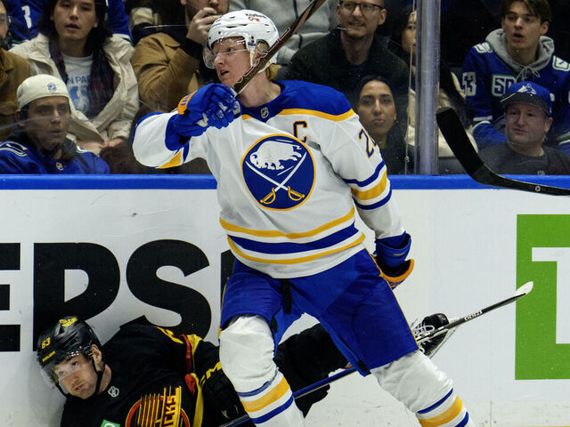 VANCOUVER, CANADA - DECEMBER 11: Rasmus Dahlin #26 of the Buffalo Sabres checks Max Sasson #63 of the Vancouver Canucks during the third period of their NHL game at Rogers Arena on December 11, 2025 in Vancouver, British Columbia, Canada.