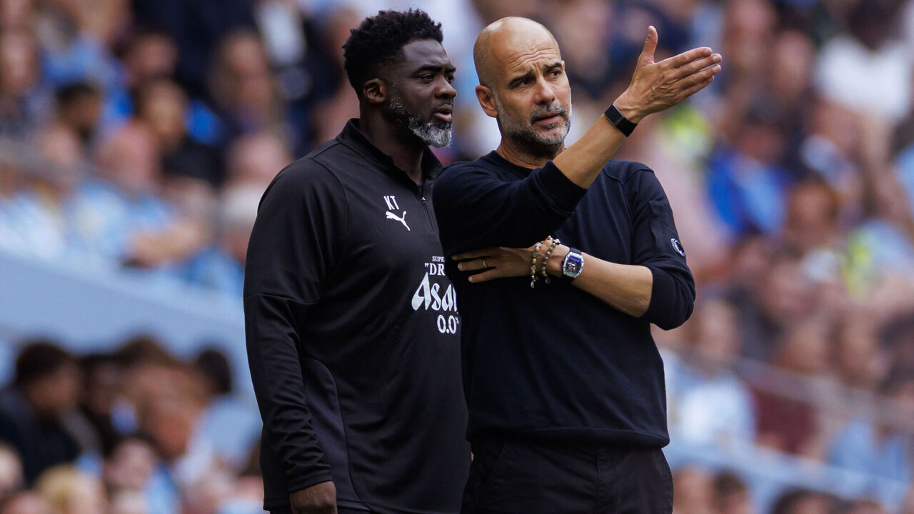 MANCHESTER, ENGLAND - AUGUST 23: Pep Guardiola the head coach / manager of Manchester City with assistant coach Kolo Toure during the Premier League match between Manchester City and Tottenham Hotspur at Etihad Stadium on August 23, 2025 in Manchester, England.