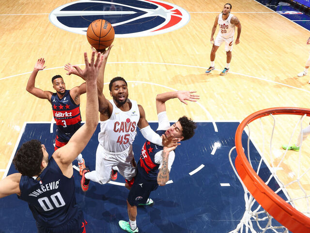WASHINGTON, DC - DECEMBER 12: Donovan Mitchell #45 of the Cleveland Cavaliers shoots the ball as Will Riley #27 and Tristan Vukcevic #00 of the Washington Wizards plays defense during the game on December 12, 2025 at Capital One Arena in Washington, DC. Mandatory Copyright Notice: Copyright 2025 NBAE