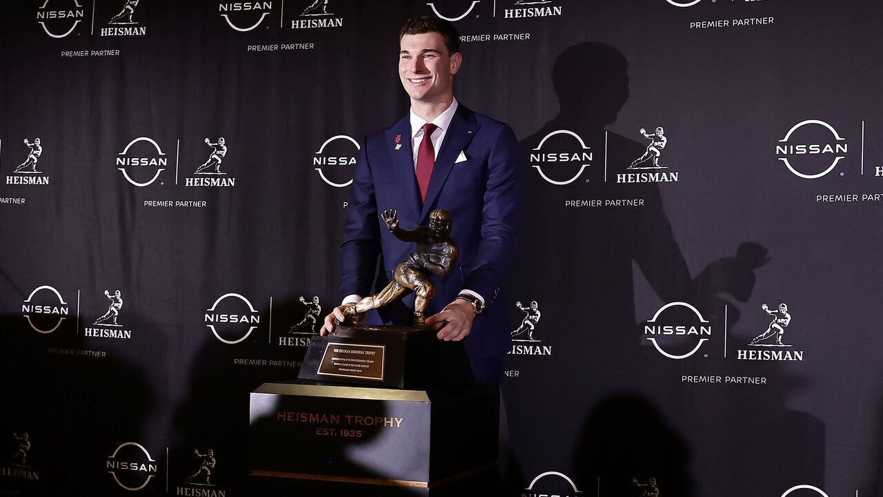 NEW YORK, NEW YORK - DECEMBER 13: Heisman Trophy candidate quarterback Fernando Mendoza of the Indiana Hoosiers poses with the Heisman Memorial Trophy before the 2025 Heisman Trophy Presentation at Marriott Marquis Hotel on December 13, 2025 in New York City.
