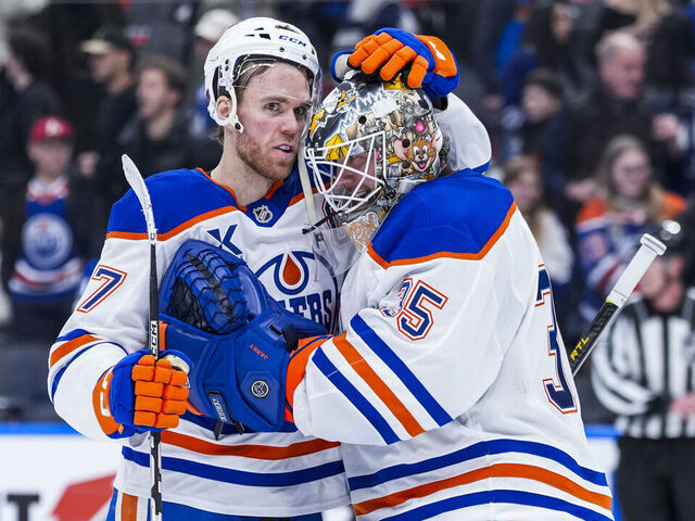 TORONTO, CANADA - DECEMBER 13: Connor McDavid #97 congratulates Tristan Jarry #35 of the Edmonton Oilers on a win over the Toronto Maple Leafs during the third period at the Scotiabank Arena on December 13, 2025 in Toronto, Ontario, Canada.