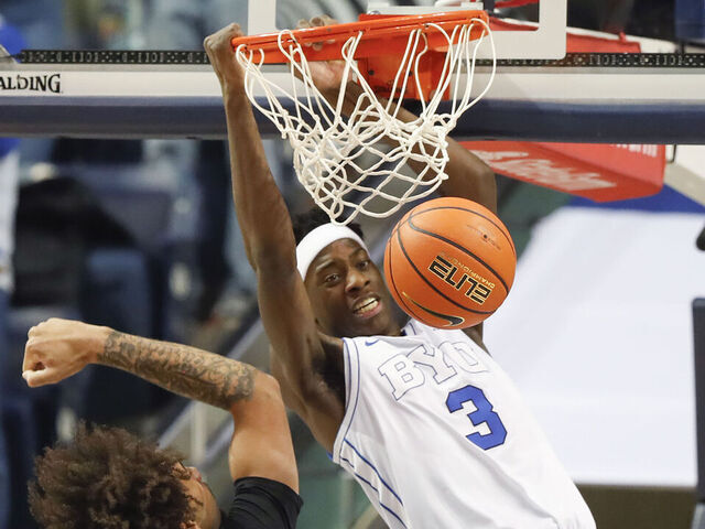 PROVO, UT - DECEMBER 13: AJ Dybantsa #3 of the Brigham Young Cougars dunks over Osiris Grady #9 of the University of California Riverside Highlanders during the first half of their game at the Marriott Center on December 13, 2025 in Provo, Utah.