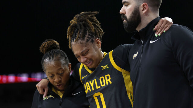 FORT WORTH, TEXAS - DECEMBER 14: Taliah Scott #0 of the Baylor Bears is helped off the floor during the first half against the Texas Longhorns at Dickies Arena on December 14, 2025 in Fort Worth, Texas.