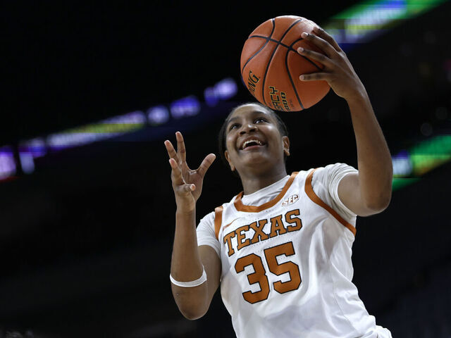 FORT WORTH, TEXAS - DECEMBER 14: Madison Booker #35 of the Texas Longhorns goes to the basket as Yuting Deng #7 of the Baylor Bears defends during the second half at Dickies Arena on December 14, 2025 in Fort Worth, Texas.