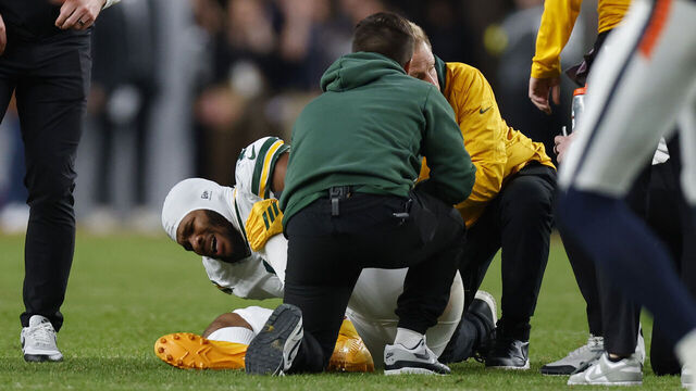 DENVER, COLORADO - DECEMBER 14: Micah Parsons #1 of the Green Bay Packers is attended to by medical staff during the fourth quarter against the Denver Broncos at Empower Field At Mile High on December 14, 2025 in Denver, Colorado.