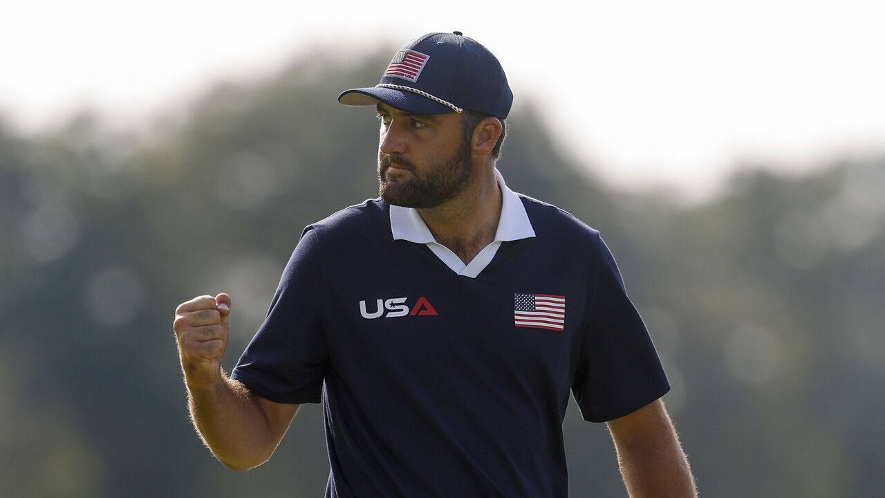 FARMINGDALE, NEW YORK - SEPTEMBER 27: Scottie Scheffler of Team United States celebrates after making his putt to win the tenth hole during the Saturday morning foursomes matches of the 2025 Ryder Cup at Black Course at Bethpage State Park Golf Course on September 27, 2025 in Farmingdale, New York.