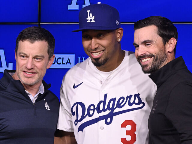 Los Angeles, CA - December 12: Former New York Mets closer Edwin Diaz, center, introduced to the Los Angeles Dodgers by Andrew Friedman, President of baseball operations and Brandon Gomes, General manager at Dodger Stadium in Los Angeles on Friday, December 12, 2025.