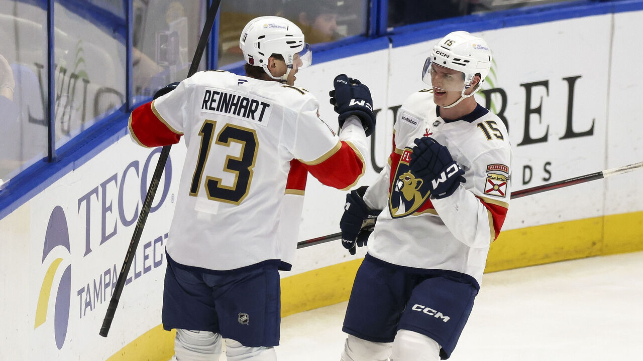 TAMPA, FL - DECEMBER 15: Sam Reinhart #13 and Anton Lundell #15 of the Florida Panthers celebrate a goal against the Tampa Bay Lightning at Benchmark International Arena on December 15, 2025 in Tampa, Florida.