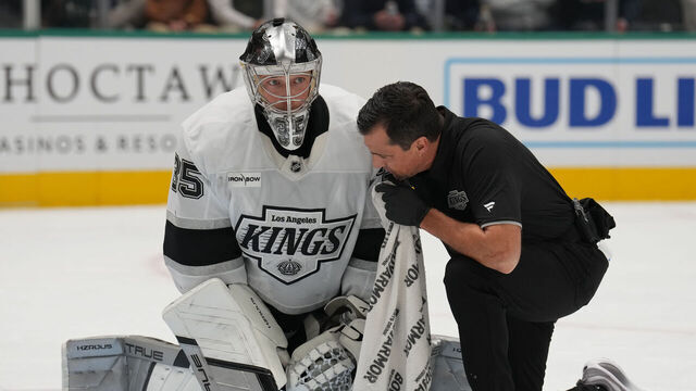 DALLAS, TX - DECEMBER 15: Darcy Kuemper #35 of the Los Angeles Kings gets looked at against the Dallas Stars at the American Airlines Center on December 15, 2025 in Dallas, Texas.