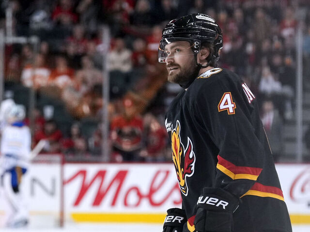 CALGARY, CANADA - DECEMBER 08: Rasmus Andersson #4 of the Calgary Flames skates from the bench after scoring on the Buffalo Sabres during the game at the Scotiabank Saddledome on December 08, 2025 in Calgary, Alberta.