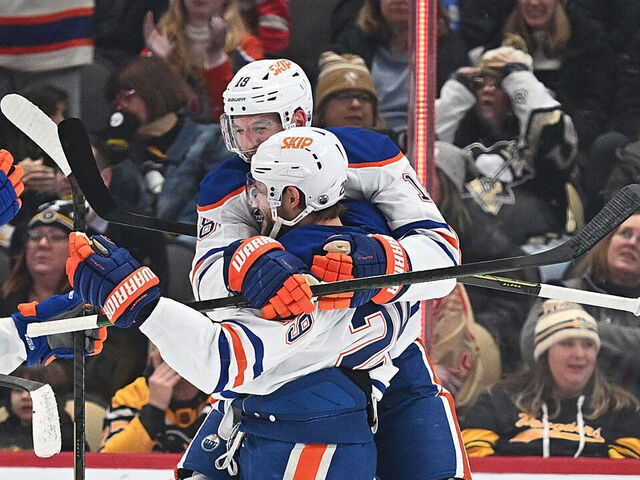 PITTSBURGH, PENNSYLVANIA - DECEMBER 16: Leon Draisaitl #29 of the Edmonton Oilers is mobbed by teammates after getting his 1000th career point on an assist in the first period against the Pittsburgh Penguins at PPG PAINTS Arena on December 16, 2025 in Pittsburgh, Pennsylvania.