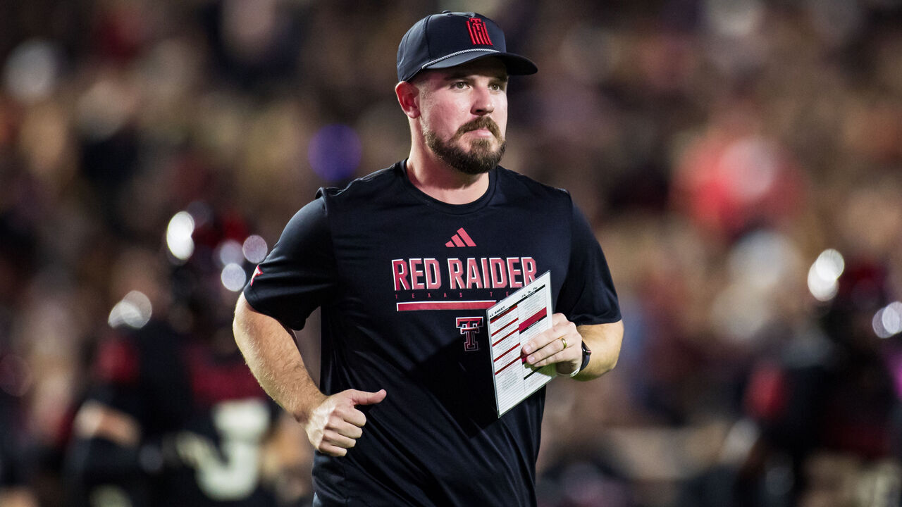 LUBBOCK, TEXAS - OCTOBER 11: Offensive Coordinator Mack Leftwich of the Texas Tech Red Raiders runs across the field at halftime of the game against the Kansas Jayhawks at Jones AT&T Stadium on October 11, 2025 in Lubbock, Texas.