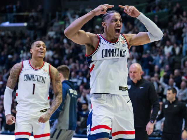 HARTFORD, CONNECTICUT - DECEMBER 16: Jayden Ross #23 and Solo Ball #1 of the Connecticut Huskies react during the second half of an NCAA men's basketball game against the Butler Bulldogs at PeoplesBank Arena on December 16, 2025 in Hartford, Connecticut.