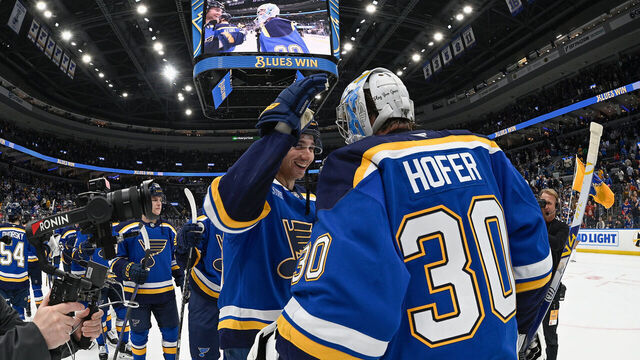 ST. LOUIS, MO - DECEMBER 17: Logan Mailloux #23 congratulates Joel Hofer #30 of the St. Louis Blues on his shutout win over the Winnipeg Jetson December 17, 2025 at the Enterprise Center in St. Louis, Missouri.