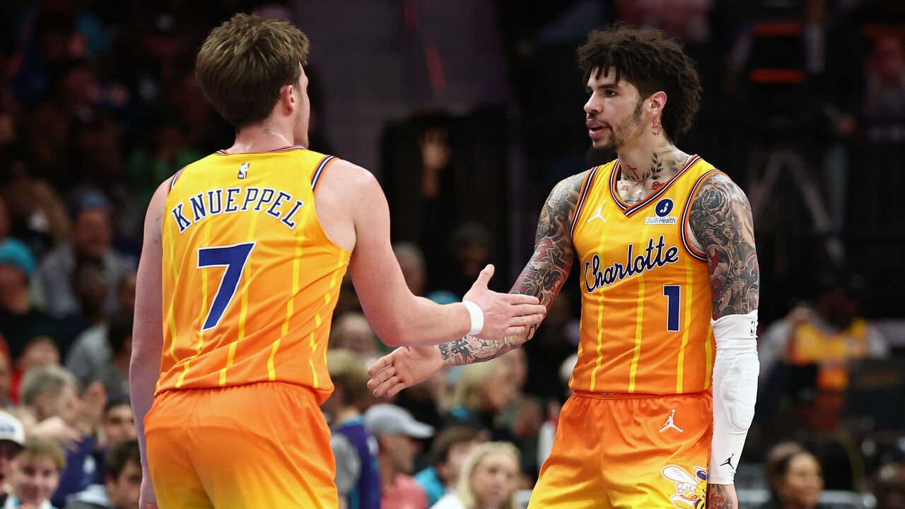 CHARLOTTE, NORTH CAROLINA - DECEMBER 18: Kon Knueppel #7 and Lamelo Ball #1 of the Charlotte Hornets react following a basket during the second quarter of the game against the Atlanta Hawks at Spectrum Center on December 18, 2025 in Charlotte, North Carolina.