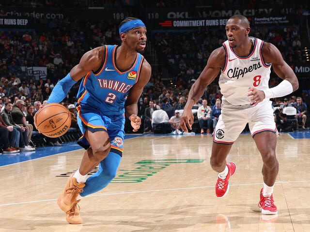 OKLAHOMA CITY, OK - DECEMBER 18: Shai Gilgeous-Alexander #2 of the Oklahoma City Thunder drives to the basket as Kris Dunn #8 of the LA Clippers plays defense during the game on December 18, 2025 at Paycom Center in Oklahoma City, Oklahoma. Mandatory Copyright Notice: Copyright 2025 NBAE