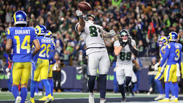 SEATTLE, WASHINGTON - DECEMBER 18: Eric Saubert #81 of the Seattle Seahawks celebrates after scoring the game-winning two point conversion to beat the Los Angeles Rams 38-27 during overtime at Lumen Field on December 18, 2025 in Seattle, Washington.