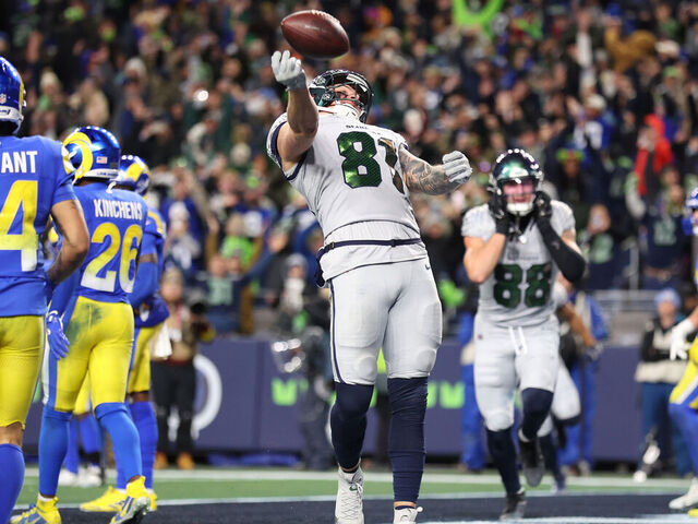 SEATTLE, WASHINGTON - DECEMBER 18: Eric Saubert #81 of the Seattle Seahawks celebrates after scoring the game-winning two point conversion to beat the Los Angeles Rams 38-27 during overtime at Lumen Field on December 18, 2025 in Seattle, Washington.