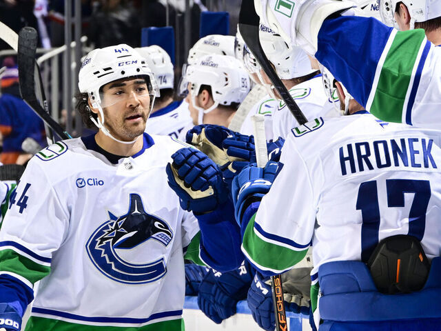 ELMONT, NEW YORK - DECEMBER 19: Kiefer Sherwood #44 of the Vancouver Canucks celebrates his third goal of the game at 18:39 for a hat-trick against the New York Islanders at UBS Arena on December 19, 2025 in Elmont, New York.